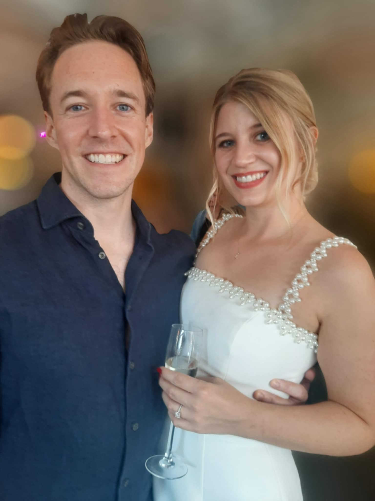 Luther and Alice dressed up with a glass of champagne