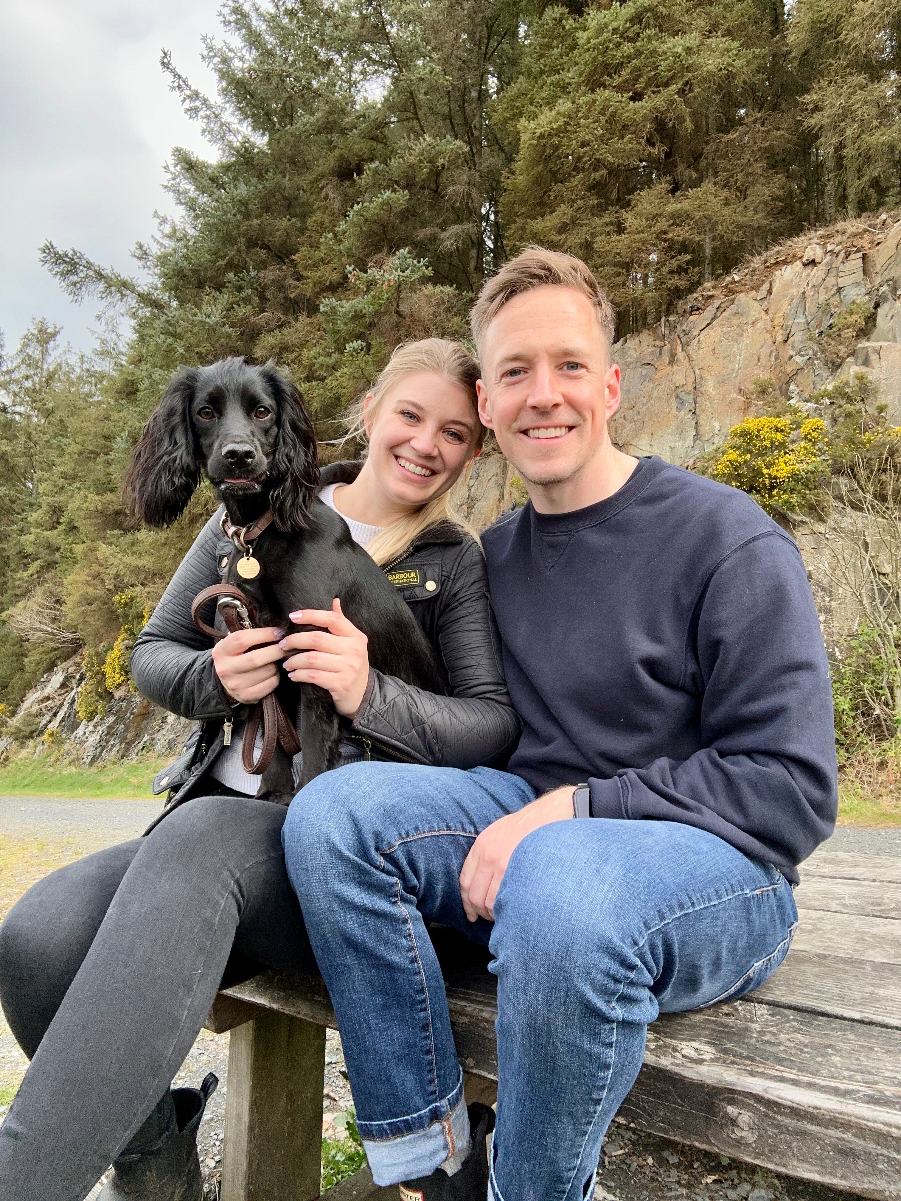 Luther and Alice on a bench with their dog in the countryside