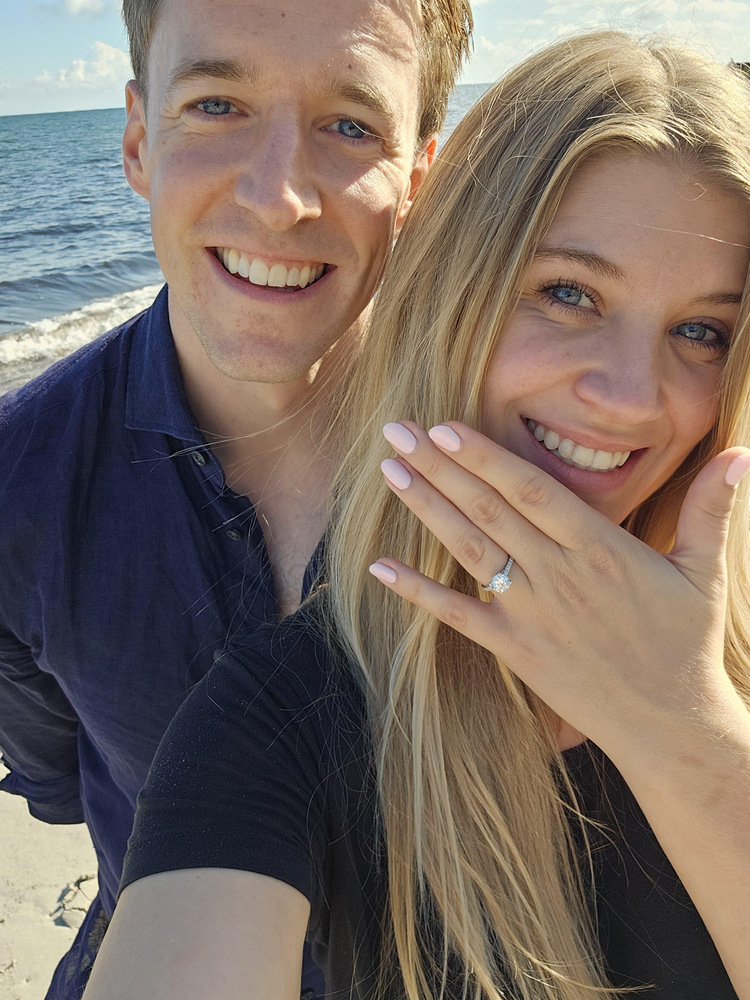 Luther and Alice on the beach the day they got engaged, showing the ring