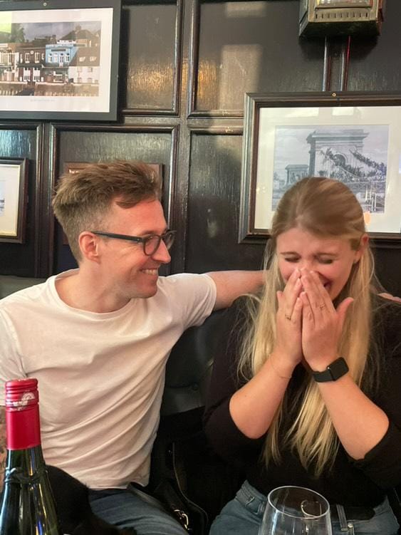 Luther and Alice laughing together in a pub