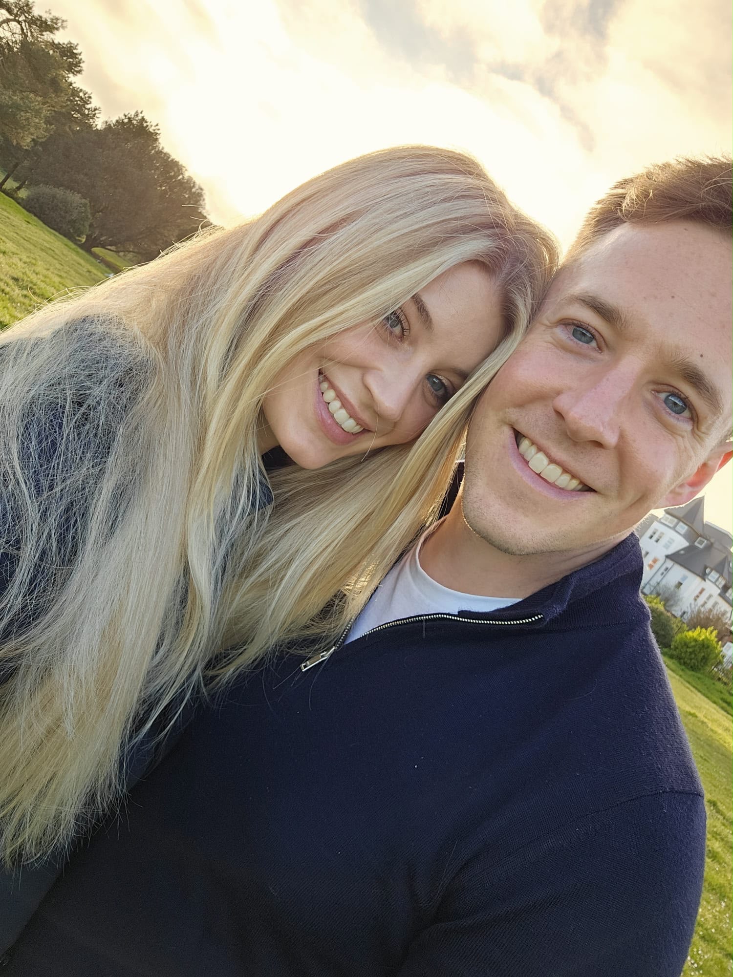Luther and Alice sharing a sunset selfie outdoors